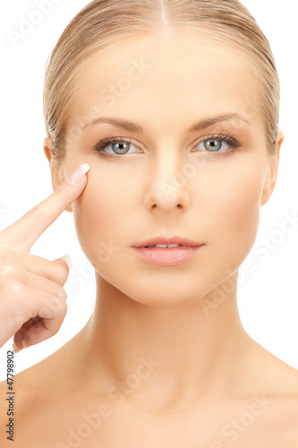 Photo: beautiful woman pointing to cheek beautiful woman pointing to cheek