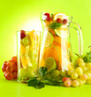 jar and glass with citrus fruits and raspberries,