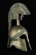 Ancient greek helmet replica on black background