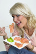 Junge Frau isst Lachs