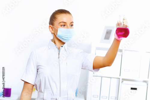 Photo: Young female scientist working in laboratory Young female scientist working in laboratory