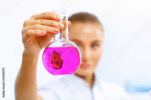 Photo: Young female scientist working in laboratory Young female scientist working in laboratory