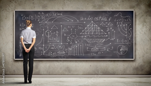 Photo: Business person against the blackboard Business person against the blackboard