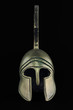 Ancient greek helmet replica on black background