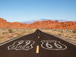 Route 66 Pavement Sign with Red Rock Mountains