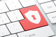 Enter button with shield with keyhole on computer keyboard