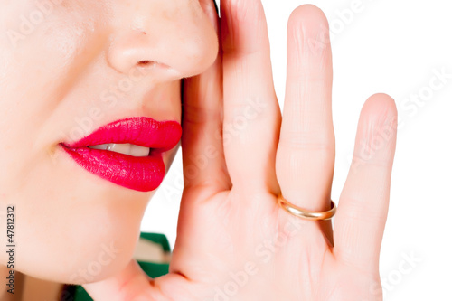 Photo: cropped image of gossiping woman cropped image of gossiping woman