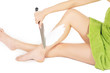 Woman shaving her legs by a knife , white background