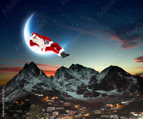 Photo: photo of santa claus sitting on the moon photo of santa claus sitting on the moon