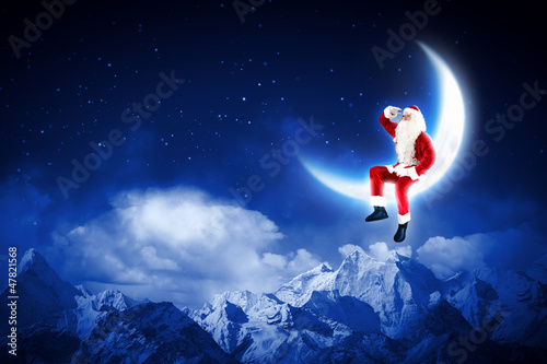 Photo: photo of santa claus sitting on the moon photo of santa claus sitting on the moon