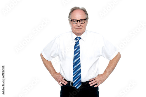 Photo: Confident business tycoon striking a pose Confident business tycoon striking a pose