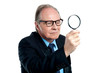 Detective  exploring through a magnifying glass