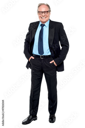 Photo: Happy entrepreneur striking a confident pose Happy entrepreneur striking a confident pose