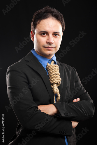 Photo: Businessman with a rope around neck, tax pressure concept Businessman with a rope around neck, tax pressure concept