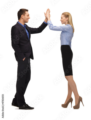 Photo: man and woman giving a high five man and woman giving a high five