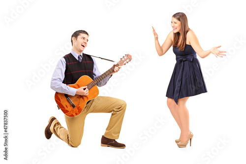 Photo: A male playing on a guitar and singing to his girlfriend A male playing on a guitar and singing to his girlfriend