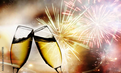 Photo: champagne glasses against fireworks champagne glasses against fireworks