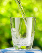 Glass of water on nature background
