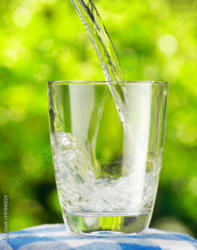 Photo: Glass of water on nature background Glass of water on nature background
