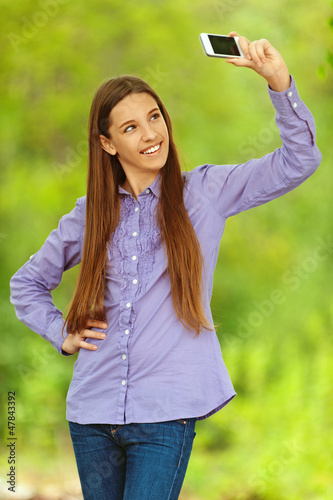 Photo: smiling teenage girl photographing themselves smiling teenage girl photographing themselves