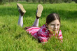 happy girl lie on the green grass