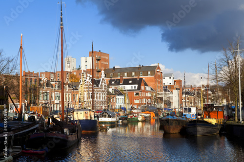 Photo: sunny canal in Groningen with many river boats sunny canal in Groningen with many river boats