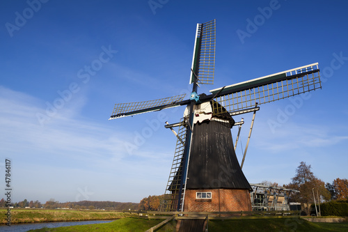 Photo: Dutch windmill over blue sky Dutch windmill over blue sky