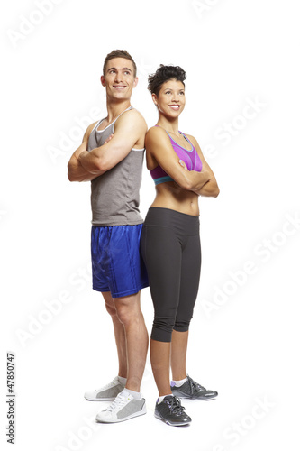Photo: Young man and woman relaxing in sports outfits Young man and woman relaxing in sports outfits