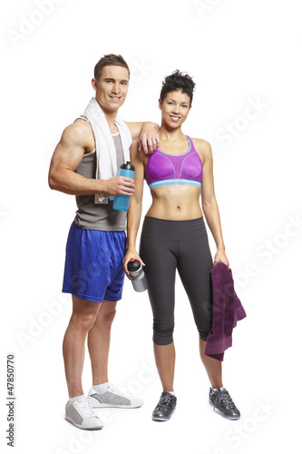Photo: Young man and woman relaxing in sports outfits Young man and woman relaxing in sports outfits