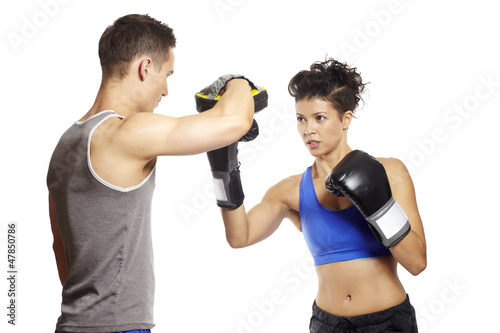 Photo: Young man and woman boxing sparring Young man and woman boxing sparring