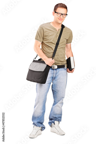 Photo: Male student with shoulder bag holding a book Male student with shoulder bag holding a book
