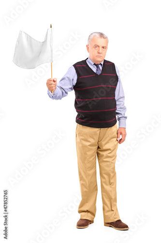 Photo: Sad senior man waving a white flag Sad senior man waving a white flag