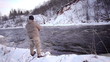 Man fishing trout in forest river