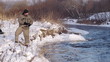 Man fishing trout in forest river