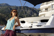 Young beautiful girl near the yacht