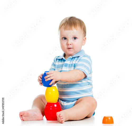 Photo: baby boy playing with toys, isolated over white baby boy playing with toys, isolated over white