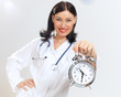 Young female doctor with clocks