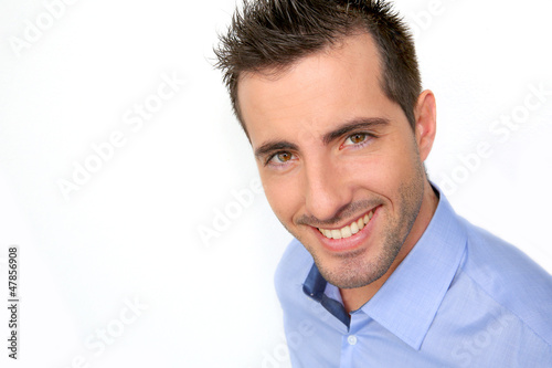 Photo: Smiling handsome guy leaning on white background Smiling handsome guy leaning on white background
