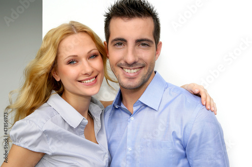 Photo: Cheerful couple looking at camera Cheerful couple looking at camera