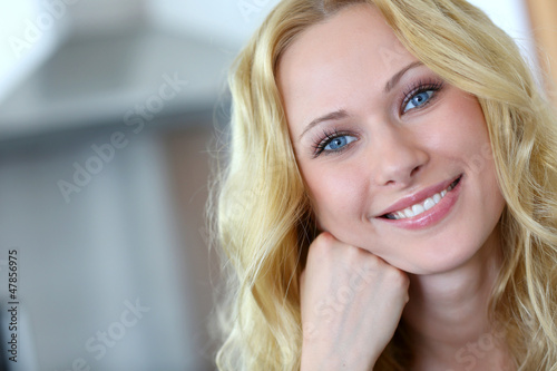 Photo: Portrait of smiling blond woman with curly hair Portrait of smiling blond woman with curly hair