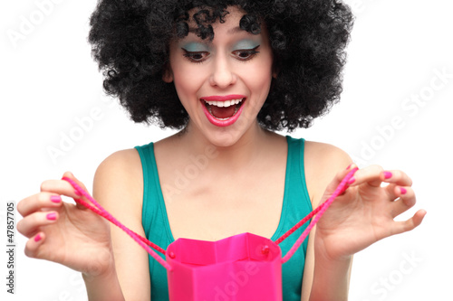 Photo: Woman with afro looking into shopping bag Woman with afro looking into shopping bag