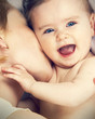 mother kissed her little baby, close-up