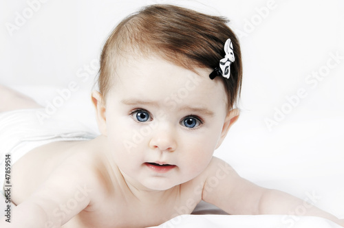 Photo: Portrait of a cute little baby on a white background Portrait of a cute little baby on a white background
