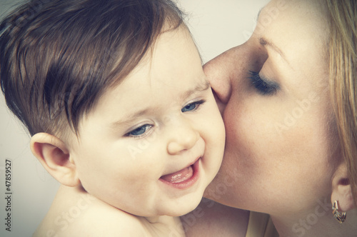 Photo: mother kissed her little baby, close-up mother kissed her little baby, close-up