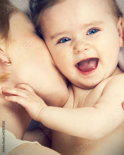Photo: mother kissed her little baby, close-up mother kissed her little baby, close-up