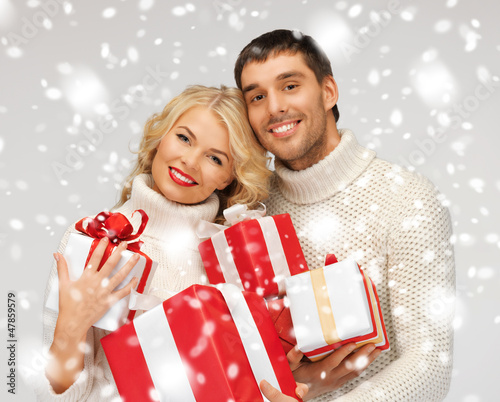 Photo: romantic couple in a sweaters with gift boxes romantic couple in a sweaters with gift boxes