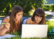 Photo: Happy young girls having fun using a computer Happy young girls having fun using a computer