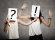 women with interrogation symbols in front of their faces