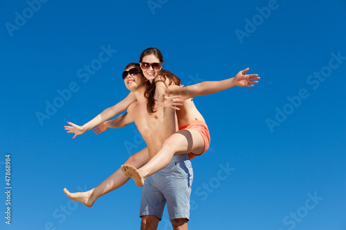 Photo: Happy Young Couple Together On The Beach Happy Young Couple Together On The Beach