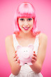 Attractive woman holding piggy bank